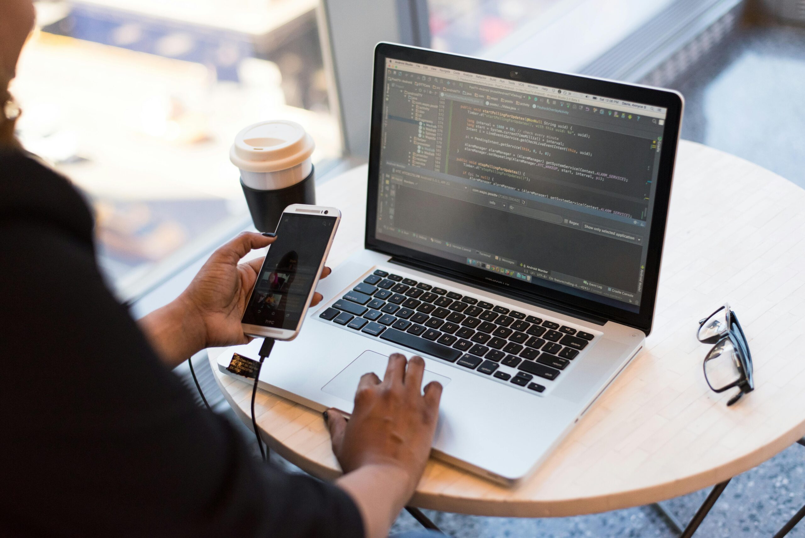 A software tester performing testing of a mobile application.